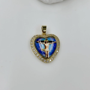 Detailed view of a gold heart pendant featuring a religious icon and sparkling zircons