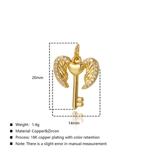 Macro shot of 18K gold plated heart wing key pendant with dimensions 20x14mm