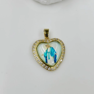 Macro detail of gold heart pendant with zircon border and Virgin Mary icon inlay