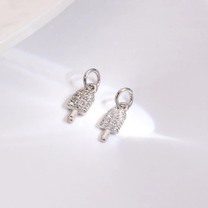 Macro shot of silver metal ice cream pendants with sparkling cubic zirconia inlay detail