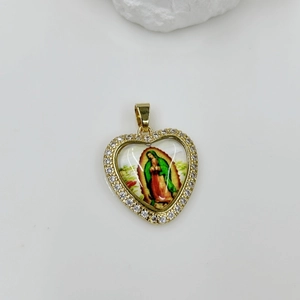 Macro detail of gold-plated heart pendant with Virgin Mary image and crystal border