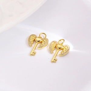Detailed view of heart-shaped angel wing key charms in gold finish with zircon inlay