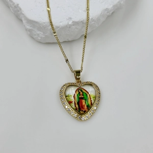 Close-up of heart-shaped Virgin Mary pendant with colorful icons and sparkling zircon gems