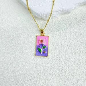 Detailed close-up of a tarot-style rectangle enamel pendant with red rose and golden chain