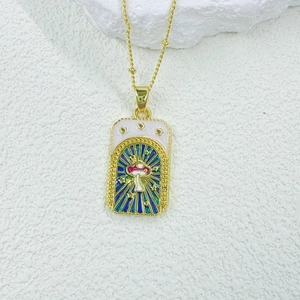 Macro detail of gold tarot pendant with mushroom and stars in blue enamel finish