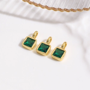 Detailed view of three square emerald green zircon pendants with 18k gold plating