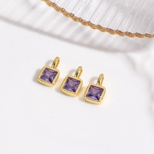 Detailed view of three purple square zircon charms with 18k gold plated mounts for DIY jewelry