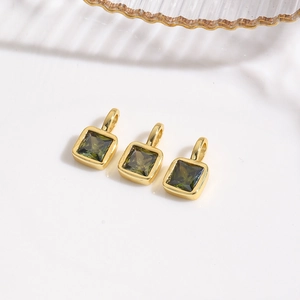 Detailed view of three 18k gold plated square charms with olive green zircon stones