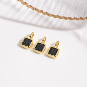 Close-up of three 18k gold plated square charms with black cubic zirconia for DIY jewelry