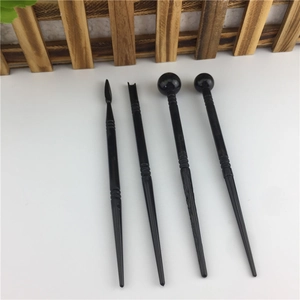 Detail of 4-piece black fondant modeling tools showing various shaping tips for sugar craft