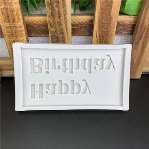 White silicone mold with Happy Birthday text for baking fondant and cake decoration