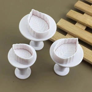 Macro detail of three-piece rose leaf fondant plungers with fine vein textures