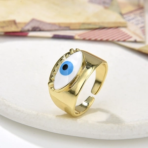 Makro-Detail des goldenen Evil-Eye-Rings mit blauem Emaille-Auge und Wimpernstruktur