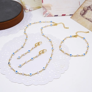 Boho sieradenset met boze oog en parels, gouden ketting, armband en oorbellen set