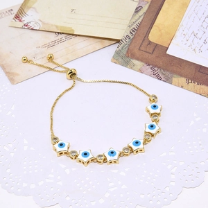 Adjustable gold star evil eye bracelet with white enamel and sparkling zircon stones