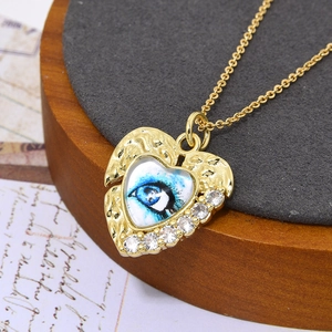 Macro-opname van hart hanger met boze oog motief en zirkonia op vintage achtergrond