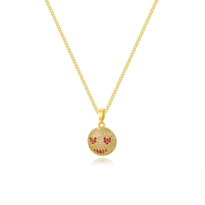 Close-up of gold-plated pendant with heart-eye smiley face and red pavé micro-inlay