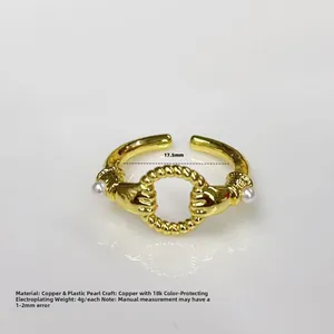 Detailed view of copper ring with 18k gold plating and double plastic pearls