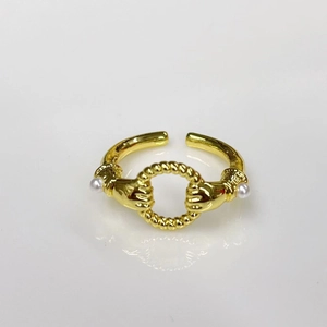 Detailed macro view of 18k gold plated open ring with dual hands holding white pearls