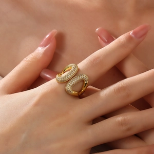 Close-up of 18k gold plated open ring featuring a double U-shape with pavé zircon stones