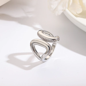 Detailed view of silver heart ring featuring pavé-set stones and polished finish