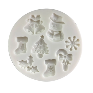 White silicone mold with Christmas tree, snowflake, and bell shapes for cake decorating