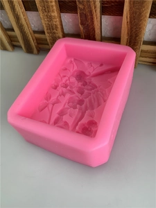 Pink rectangular silicone mold with floral butterfly patterns for soap and candle making