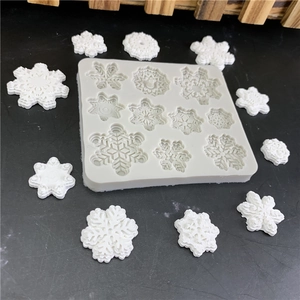 White silicone snowflake mold for chocolate and fondant cake decorating with 11 patterns