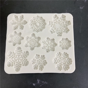 White silicone snowflake mold for cake decorating and DIY crafts with 10 varied patterns