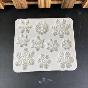 White silicone mold featuring 10 unique snowflake shapes for cake decor and DIY crafts