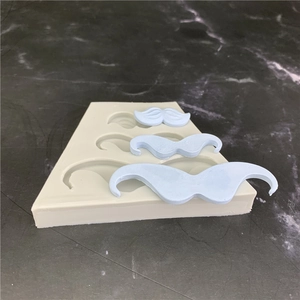 Gray silicone mustache mold for chocolate and fondant cake decoration shown at 45 degrees