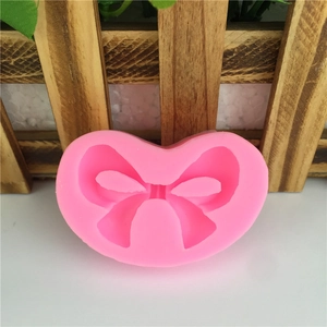 Pink bow-shaped silicone mold for DIY cake decorating and chocolate fondant craft