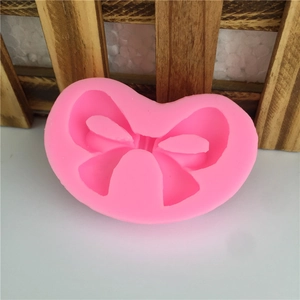 Pink silicone bow-shaped mold for DIY baking, chocolate, and fondant cake decorating