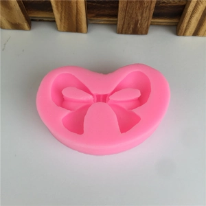 Pink bow-shaped silicone mold for DIY baking, chocolate, and fondant cake decorations