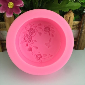 Pink round silicone mold featuring detailed rose floral relief patterns for DIY baking