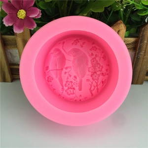 Pink round silicone mold featuring birds and flowers for DIY cake decorating and soap making
