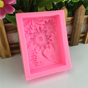 Pink silicone mold for baking and soap making featuring a detailed sunflower and vine design