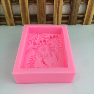 Pink rectangular silicone mold with sunflower and leaf patterns for soap making