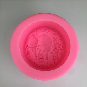 Pink silicone mold featuring embossed birds and floral patterns for cake decoration