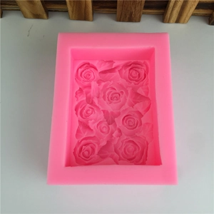 Pink silicone rectangular mold with detailed rose flower and leaf patterns for baking