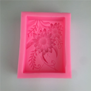 Pink rectangular silicone mold with flower and leaf patterns for fondant cake and soap