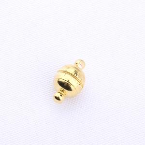 Macro shot of gold-plated barrel clasp with knurled anti-slip texture for jewelry making