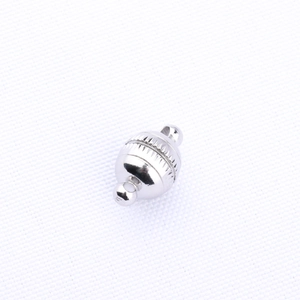 Detail view of silver magnetic clasp with textured barrel and loops for jewelry making