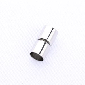 Detailed macro view of a cylindrical silver magnetic clasp for jewelry making and DIY crafts
