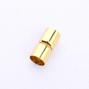 Macro shot of polished gold cylindrical magnetic clasp for handmade jewelry making