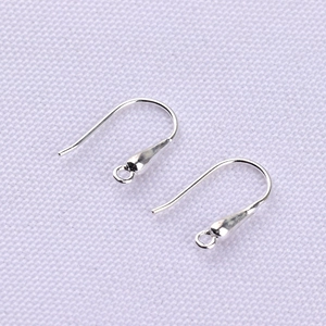 Macro shot of silver S925 hook earrings with teardrop design and small hanging loops