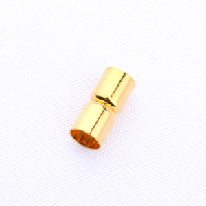 Macro detail of cylindrical gold-plated magnetic clasps for DIY jewelry making