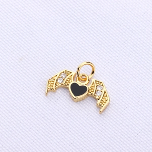 Macro shot of gothic bat wing heart pendant with black enamel and sparkling crystals