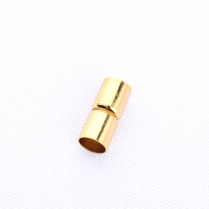 Detailed macro view of golden cylindrical magnetic jewelry clasp for DIY bracelets