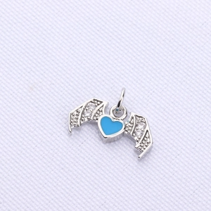 Detail of heart wing pendant with light blue enamel and sparkling micro-diamonds